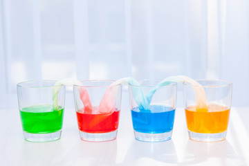 Glasses with colored liquid. Chemical experiments for children.