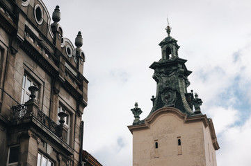 Obraz premium An old tower of the Latin Cathedral of the Assumption of the Virgin Mary in Lviv. Historical part of the city, view from below against the sky.