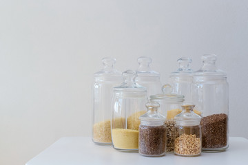 Grocery products in glass jars on the white background. Eco friendly kitchen, zero waste, plastic free.
