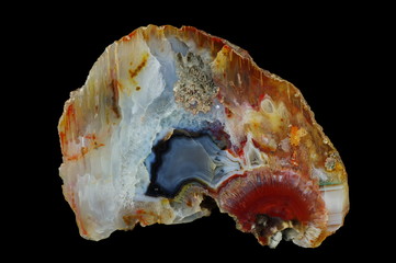 Microstalactite agate filled with quartz with sagenite inclusion. Colorful ribbons colored with...