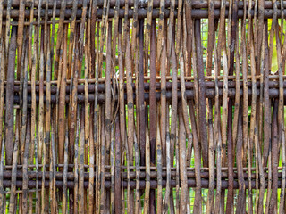 Wood twig wattle fence detail. Rustic background.