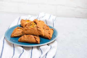 National Tatar and Bashkir dish Ocpocmaq filled with potatoes, meat, onion on blue plate with copy space