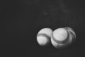 Studio baseball image with group of old used balls for sport, isolated on black background with copy space.