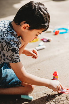 Boy Drawing with Chalk