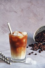 Iced coffee drink in a glass on the light background