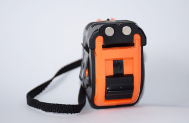 measuring device. bright tape measure in black and orange isolated on a white background, a tool in construction