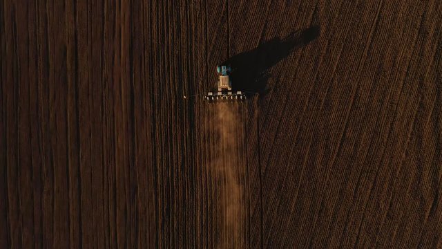 Harvester working in the field at spring and plowing the field