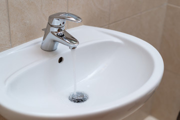 Coronavirus cleaning and disinfection recommentation guidelines: clean and disinfect high-touch household surfaces. Washing hands with soap and hot water at home bathroom
