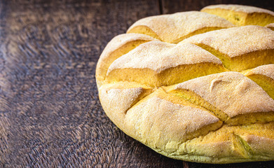 homemade corn bread made in brazil, organic and without preservatives. natural product, rustic wood background.