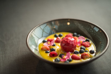 Berry sorbet with yellow mango sauce, and berries