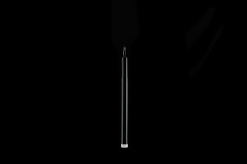 Colored markers isolated on a black background, top view