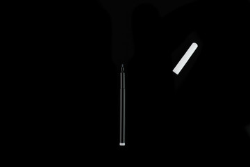 Colored markers isolated on a black background, top view