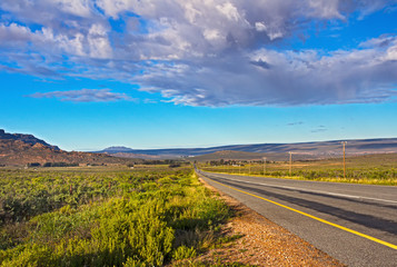 Landscape of long straight highway, and mountains