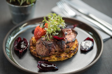 Grilled meat steak on a potato pancake