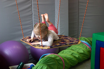 girl in tape made of elastic material. sensory experience, enhance tactile and sensitivity
