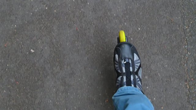 ride inliners on a paved road through a park