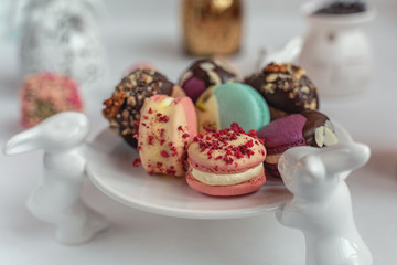 Macaron cake of different colors of large size in a beautiful layout on a light white background
