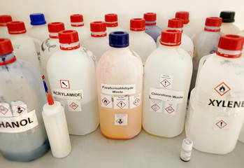 Liquid chemicals and waste bottles in a chemistry lab 