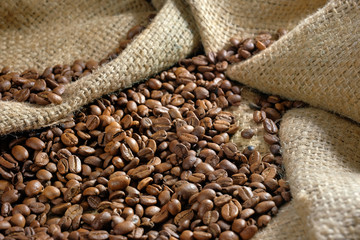Coffee roasted beans on burlap close-up. Coffee background.