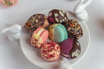 Macaron cake of different colors of large size in a beautiful layout on a light white background
