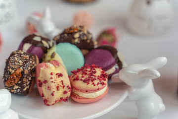 Macaron cake of different colors of large size in a beautiful layout on a light white background