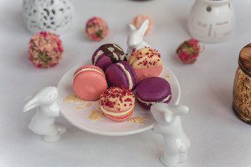 Macaron cake of different colors of large size in a beautiful layout on a light white background