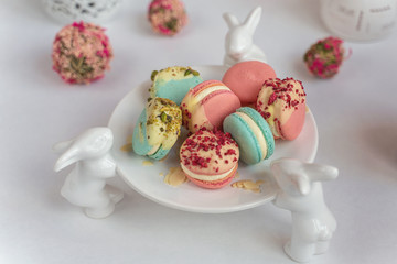 Macaron cake of different colors of large size in a beautiful layout on a light white background