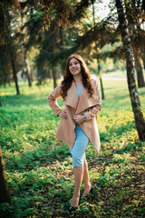 Beautiful young girl in a blue dress in a spring park