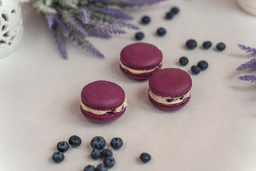 Macaron cake of different colors of large size in a beautiful layout on a light white background