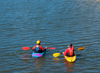 Two male kayakers on a mountain river.