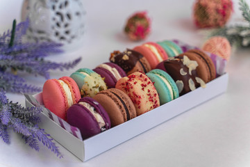 Macaron cake of different colors of large size in a beautiful layout on a light white background