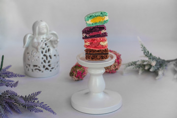 Macaron cake of different colors of large size in a beautiful layout on a light white background