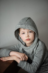 boy in a bike with capbuy silt on a chair