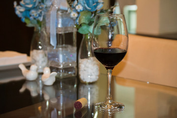 glass of red wine over the table with decoration