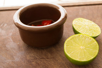 Lemon and Peper on a met cutting board with blurry and green background