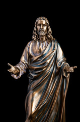 A bronze statue of a Jesus Christ isolated on black