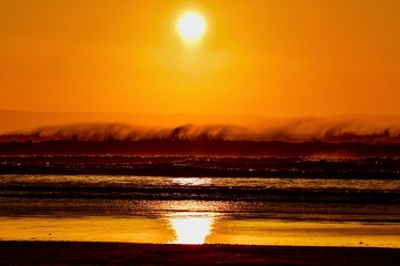 Sunset over the windy sea spray in North Devon