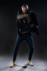 Male model posing in studio on grey background. Isolated