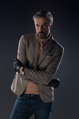 Fototapeta premium Male model posing in studio on grey background. Isolated