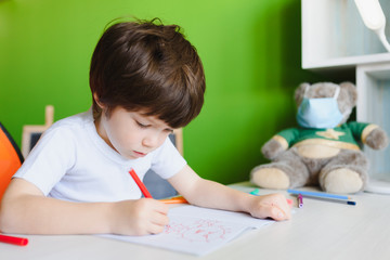 little kid drawing a coronavirus. Stay at home entertainment