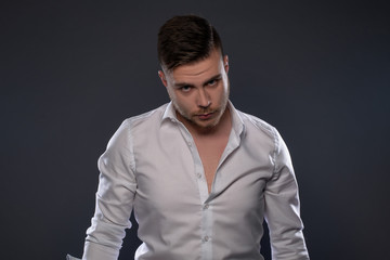 Obraz premium Portrait of beautiful man on grey background. Studio Isolated