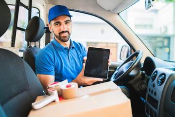 Delivery man driver using digital tablet.