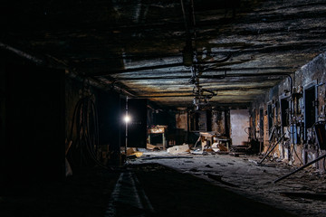 Burnt interior of industrial building basement. Walls in black soot after fire