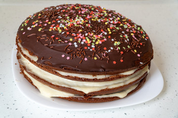 Homemade whole chocolate cake with chocolate icing and creamy filling