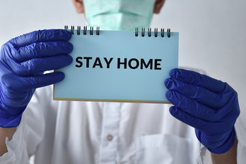 A doctor with a paper with stay at home holding on hand