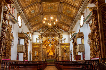 Interior and altar of historic church all painted in gold with baroque architecture in the old city...