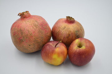 pomegranate and apple on white background