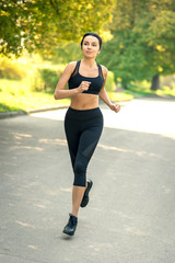 girl with dark hair in sportswear jogging. vertical frame