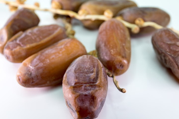 Dried dates on white background