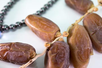 Dried Dates with rosemary beads in white background